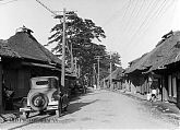 Traditional Houses and a Car in a Village on the Tokaido Highway, 20 Miles from Yokohama (1930).
